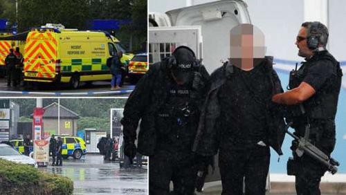 A gunman holds hostages at a petrol station in Britain and the police interfere with pictures