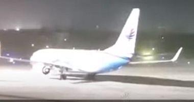 A aircraft spin around herself during her stop on the runway because a powerful video storm and photos