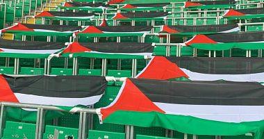 Celtic fans support the Palestinian cause before the face of St Johnson