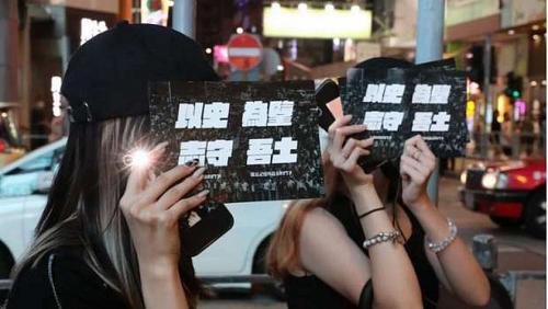 Dozens in Hong Kong shining their phones to revive the memory of Tian Anin demonstrations