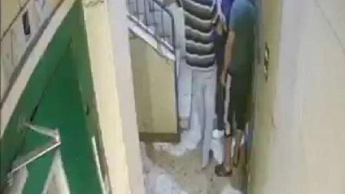 Security examines the video of the attack on an elderly and his wife in an humiliating manner